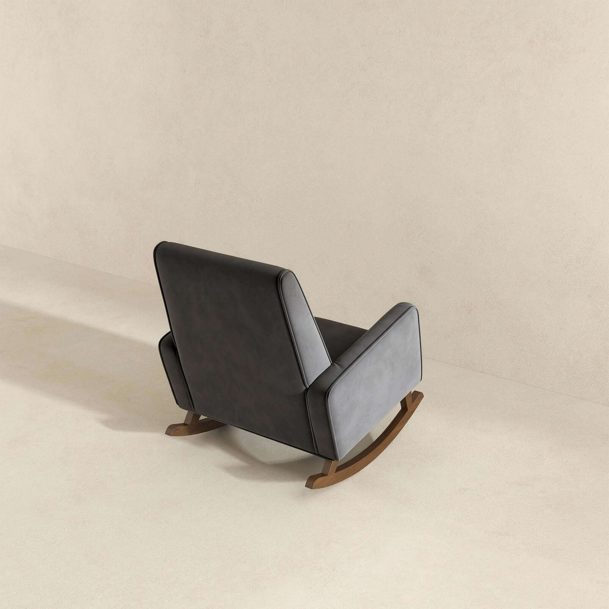 Dark gray velvet upholstered rocking chair with wooden rockers