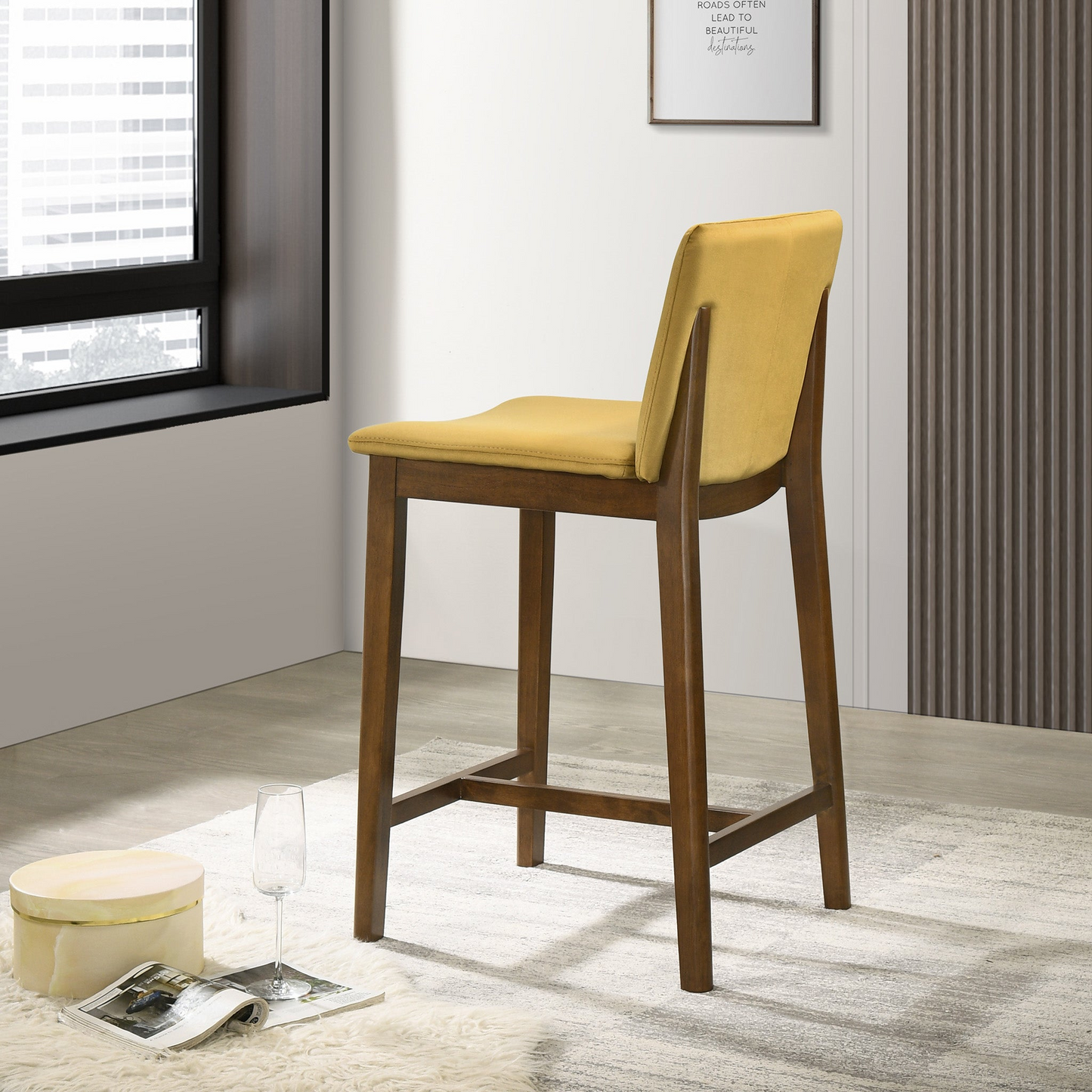 Yellow upholstered midcentury modern bar stool with dark wood legs
