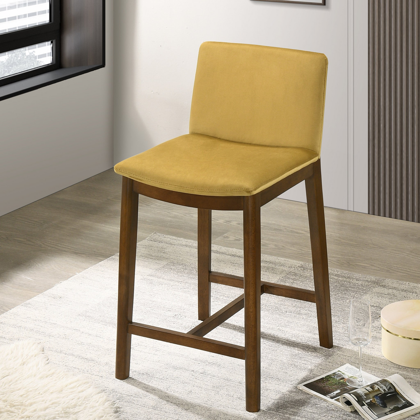 Yellow upholstered counter stool with dark wood legs