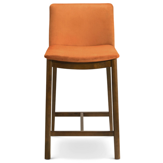 Orange velvet upholstered bar stool with a dark wood frame and footrest