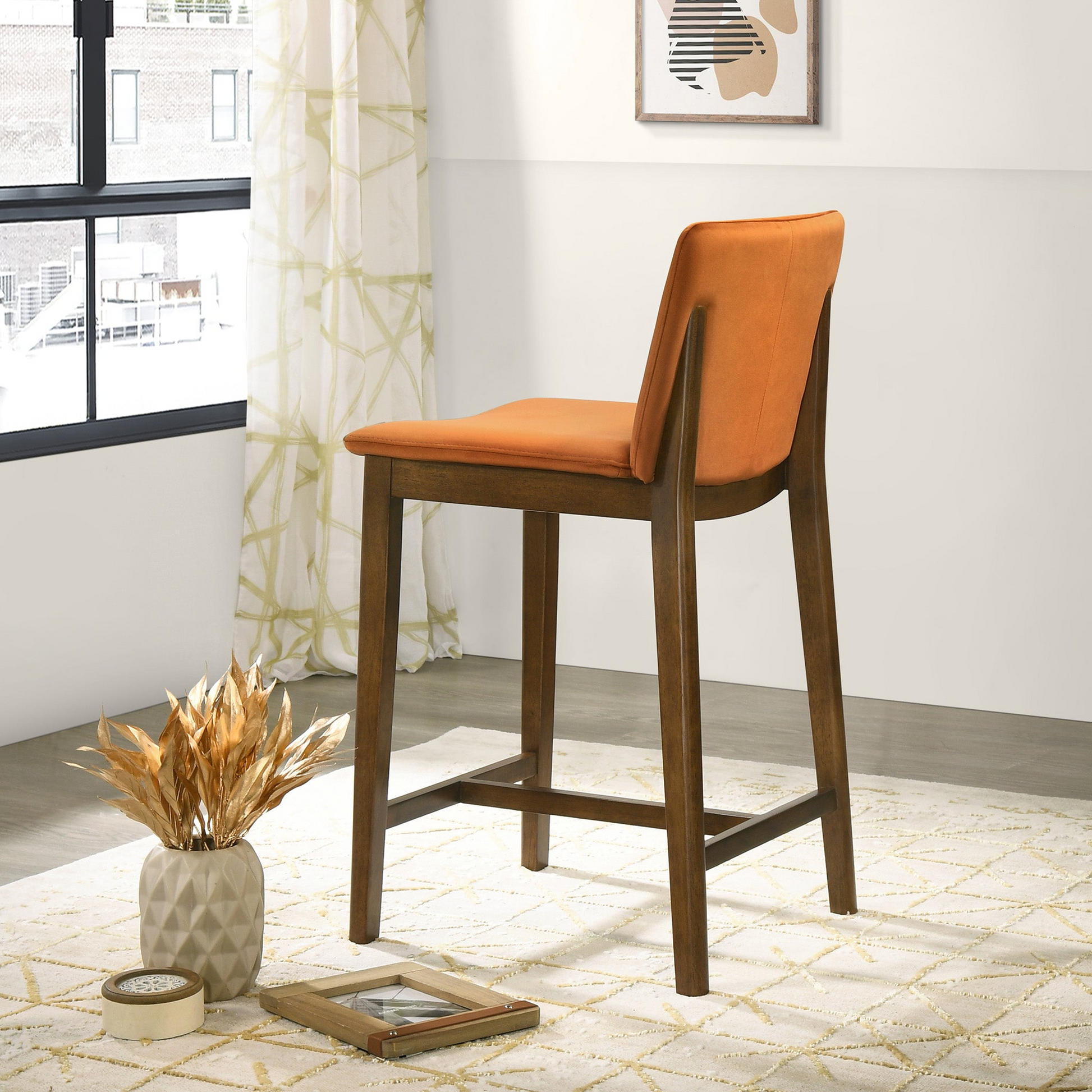 Orange upholstered bar stool with dark wood frame and legs