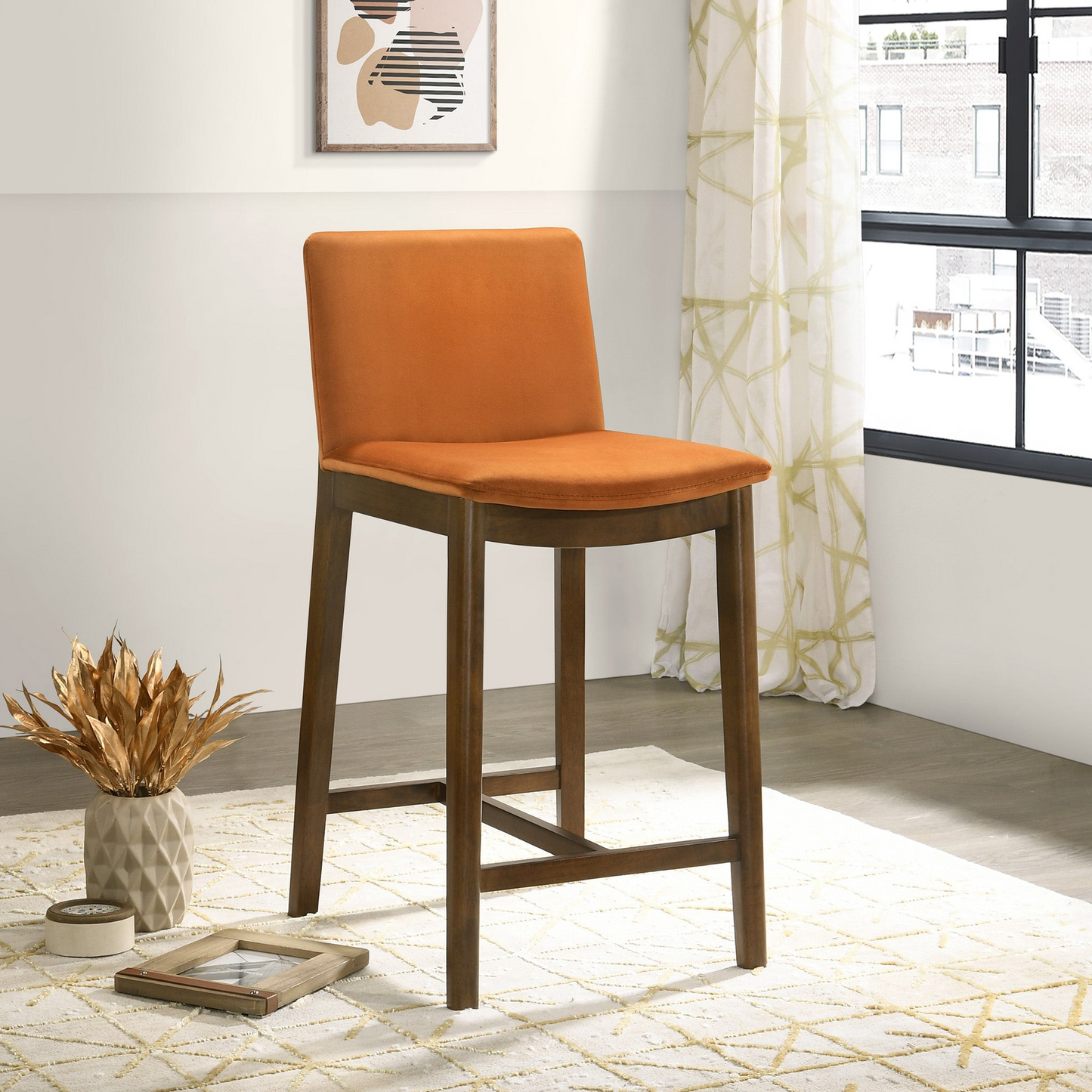 Orange velvet upholstered bar stool with dark wood legs perfect for modern kitchens