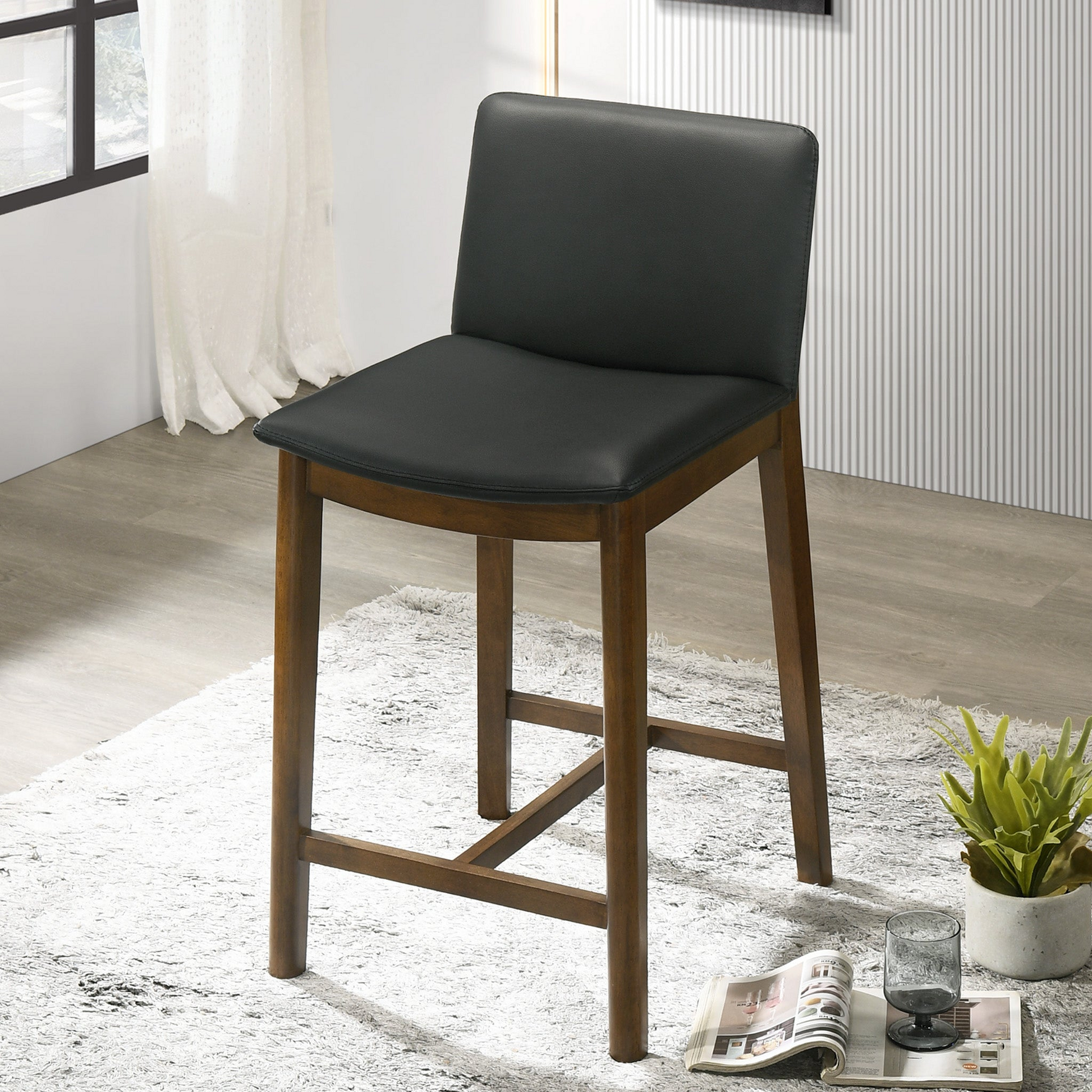 Black leather upholstered bar stool with rich wood frame ideal for modern kitchens