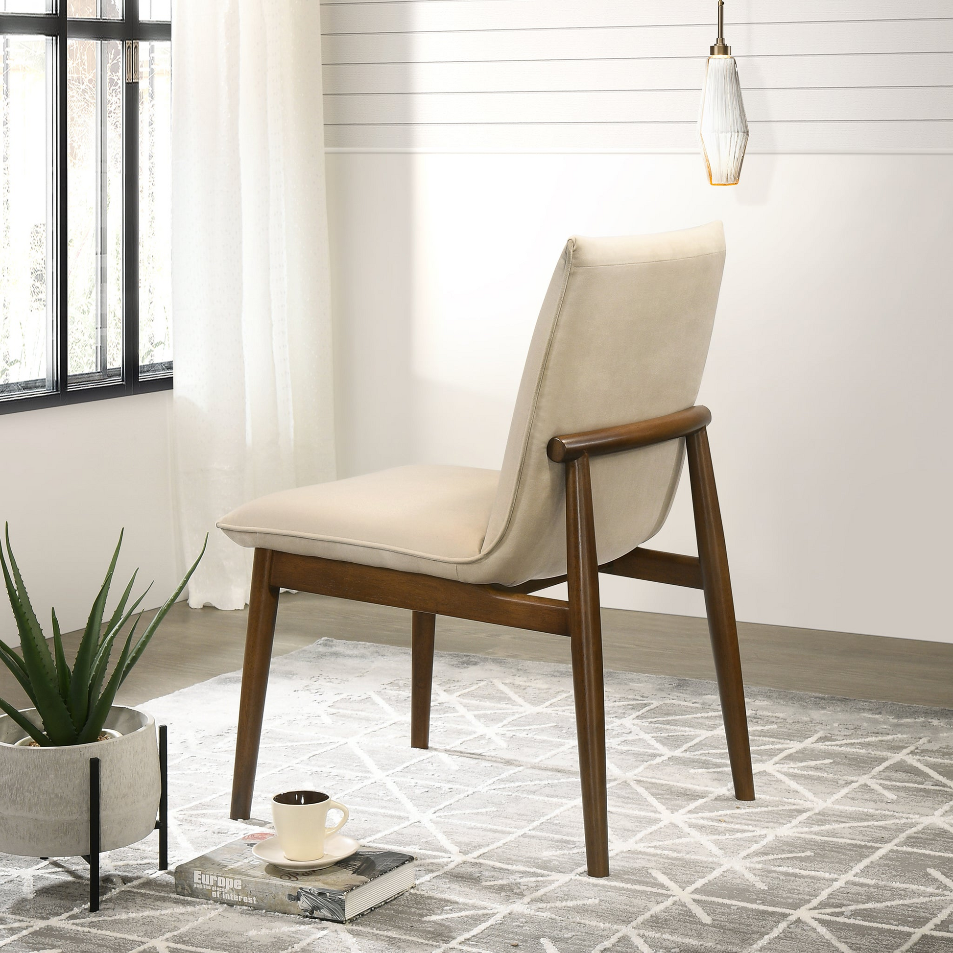 Cream fabric accent chair with curved wooden frame and dark wood legs