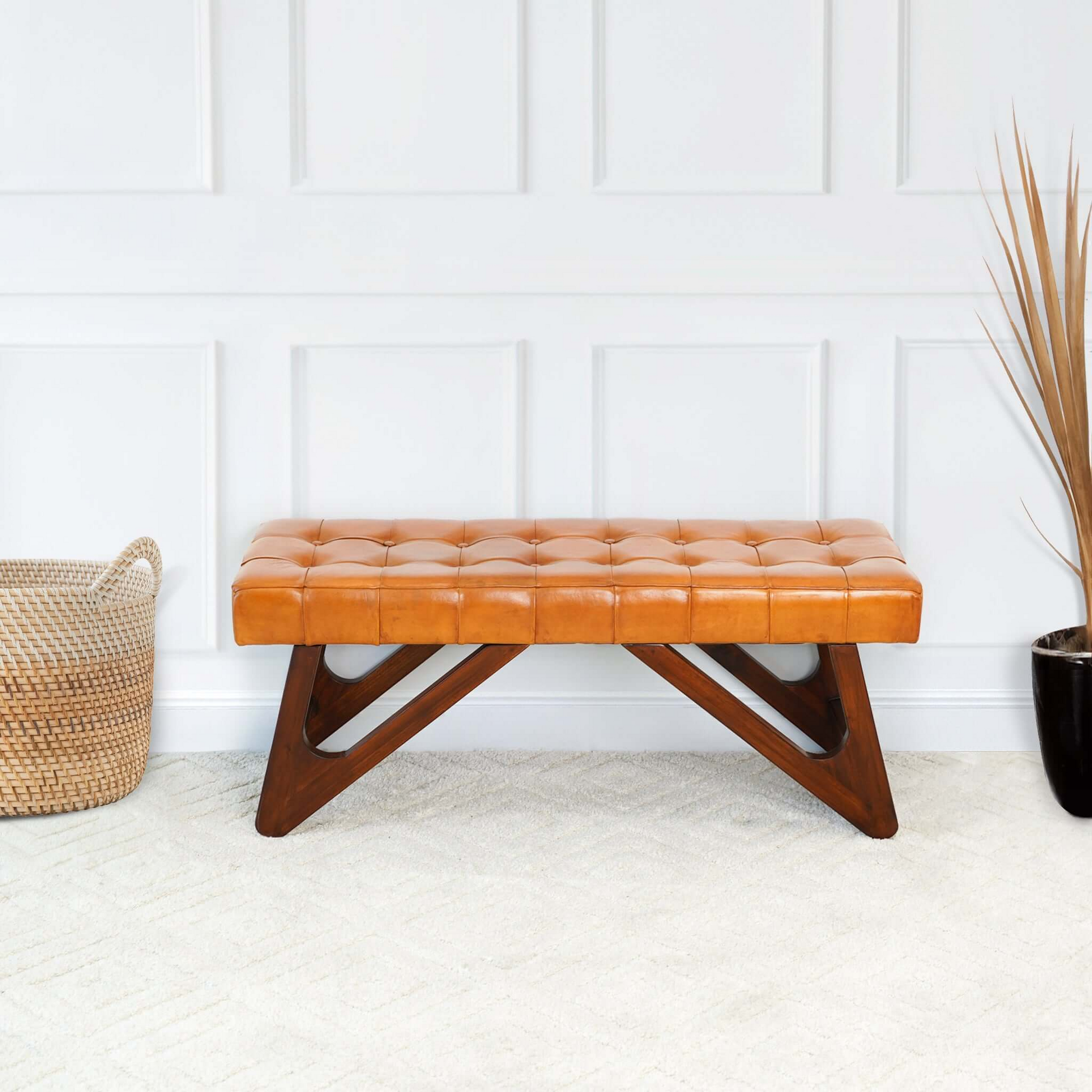 Midcentury modern tufted leather bench in rich tan with dark wood legs