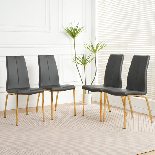 Four dark gray faux leather dining chairs with gold legs