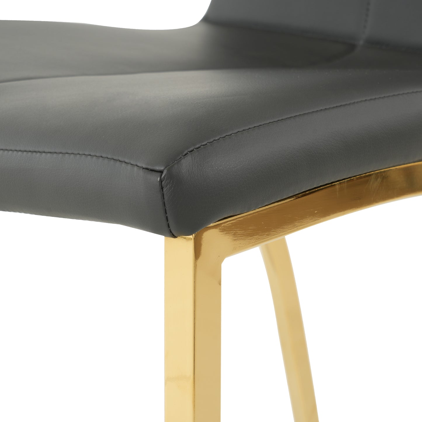 Closeup of a sleek dark gray faux leather seat with gold metal legs ideal for modern kitchens