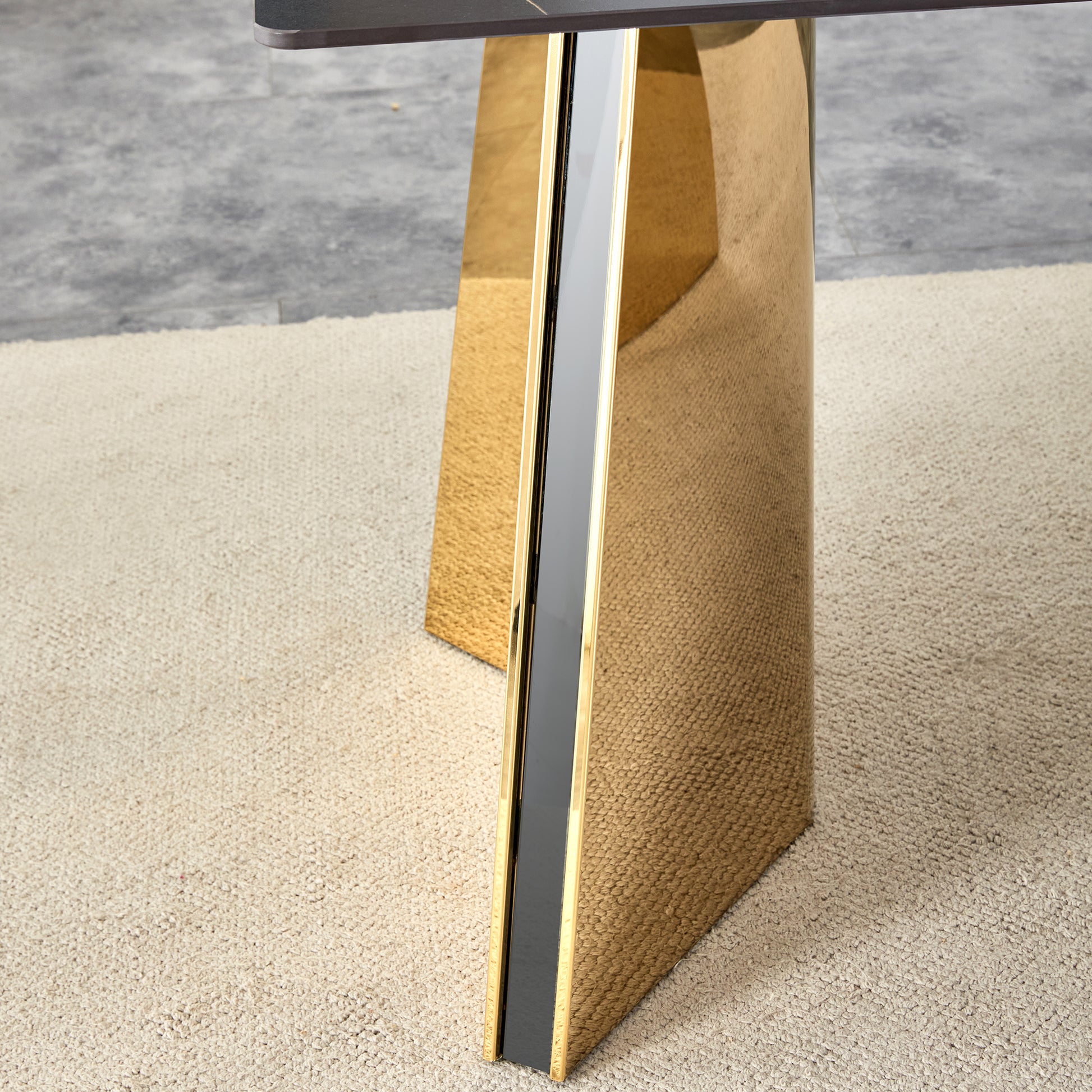Glamorous gold metal dining table leg with black inlay on shag carpet