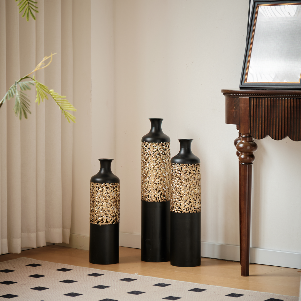 Set of three tall black vases with gold filigree accents for stylish home decor