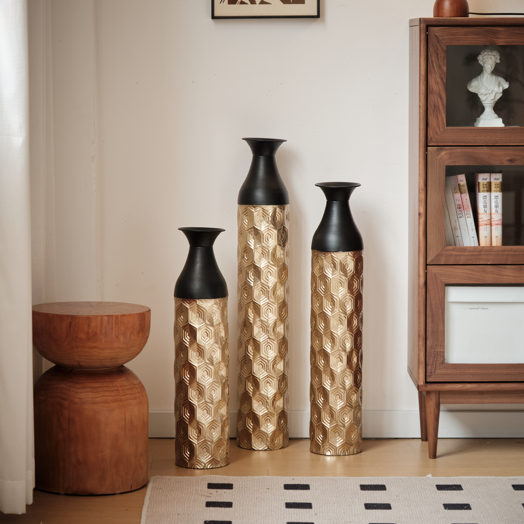 Set of three gold hexagonal patterned vases with black tops