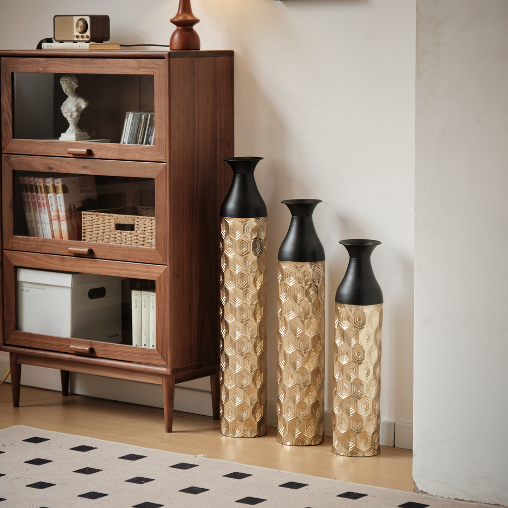 Set of three gold hexagonal tall vases with black tops