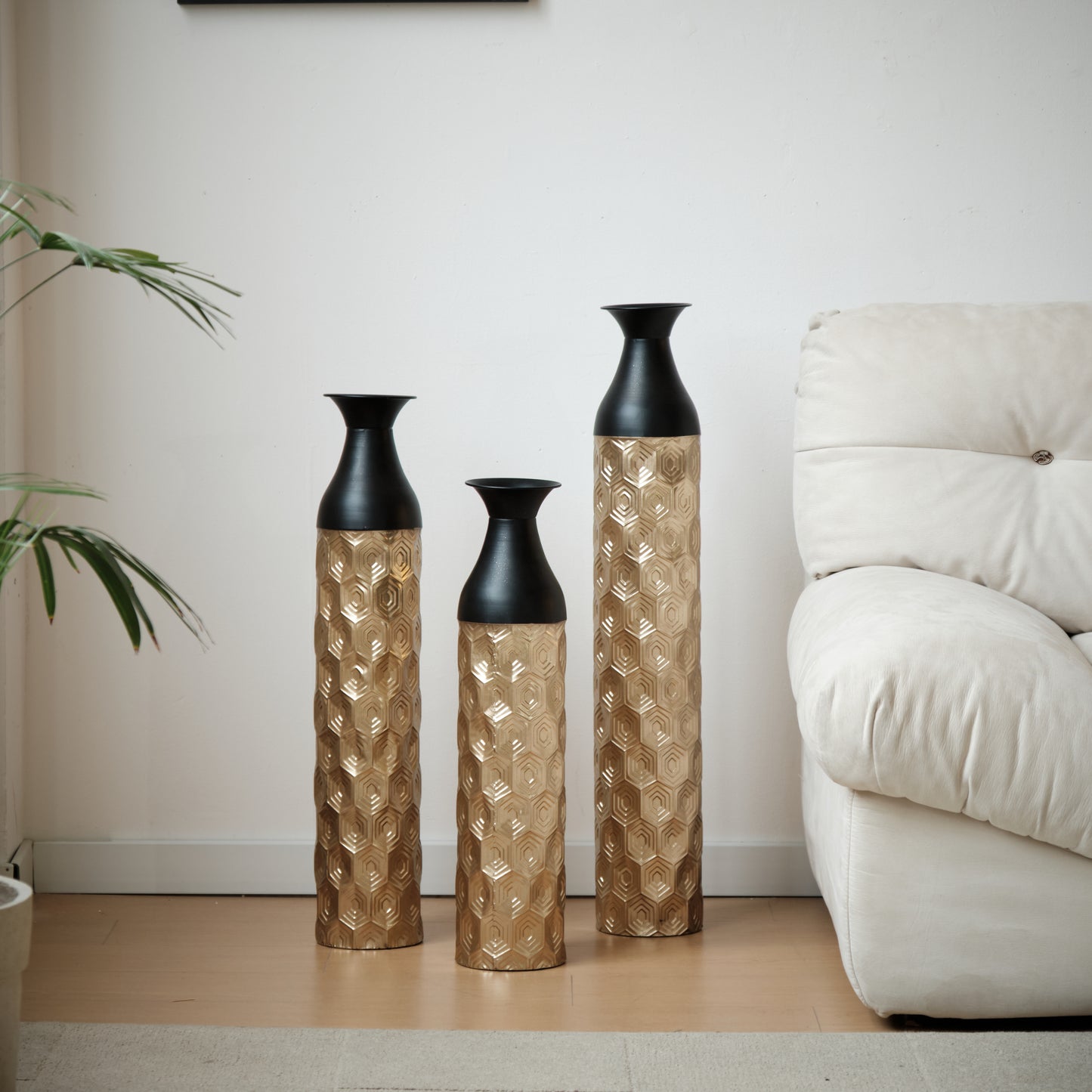 Three gold hexagon pattern vases with black tops for modern home decor
