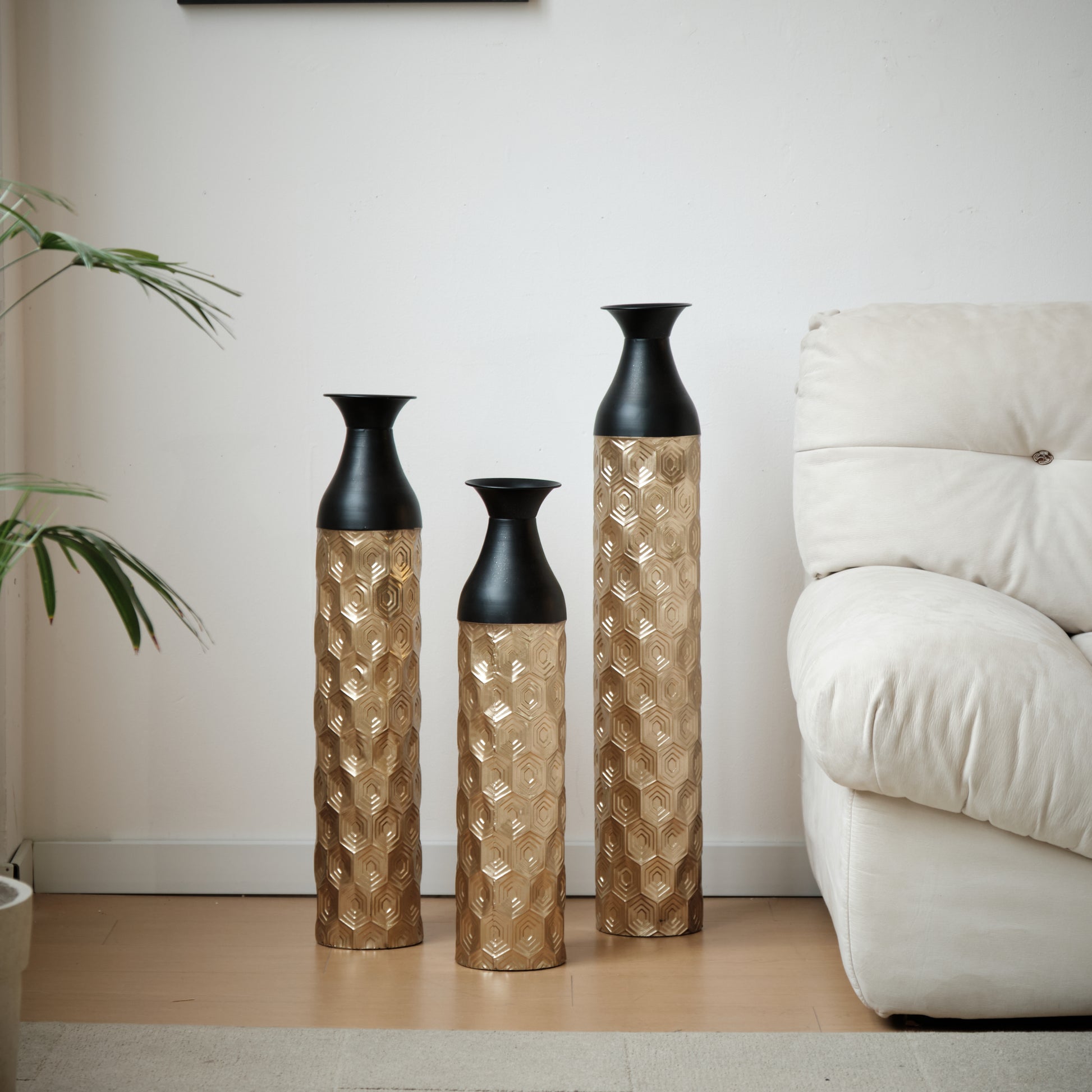 Three gold hexagon pattern vases with black tops for modern home decor