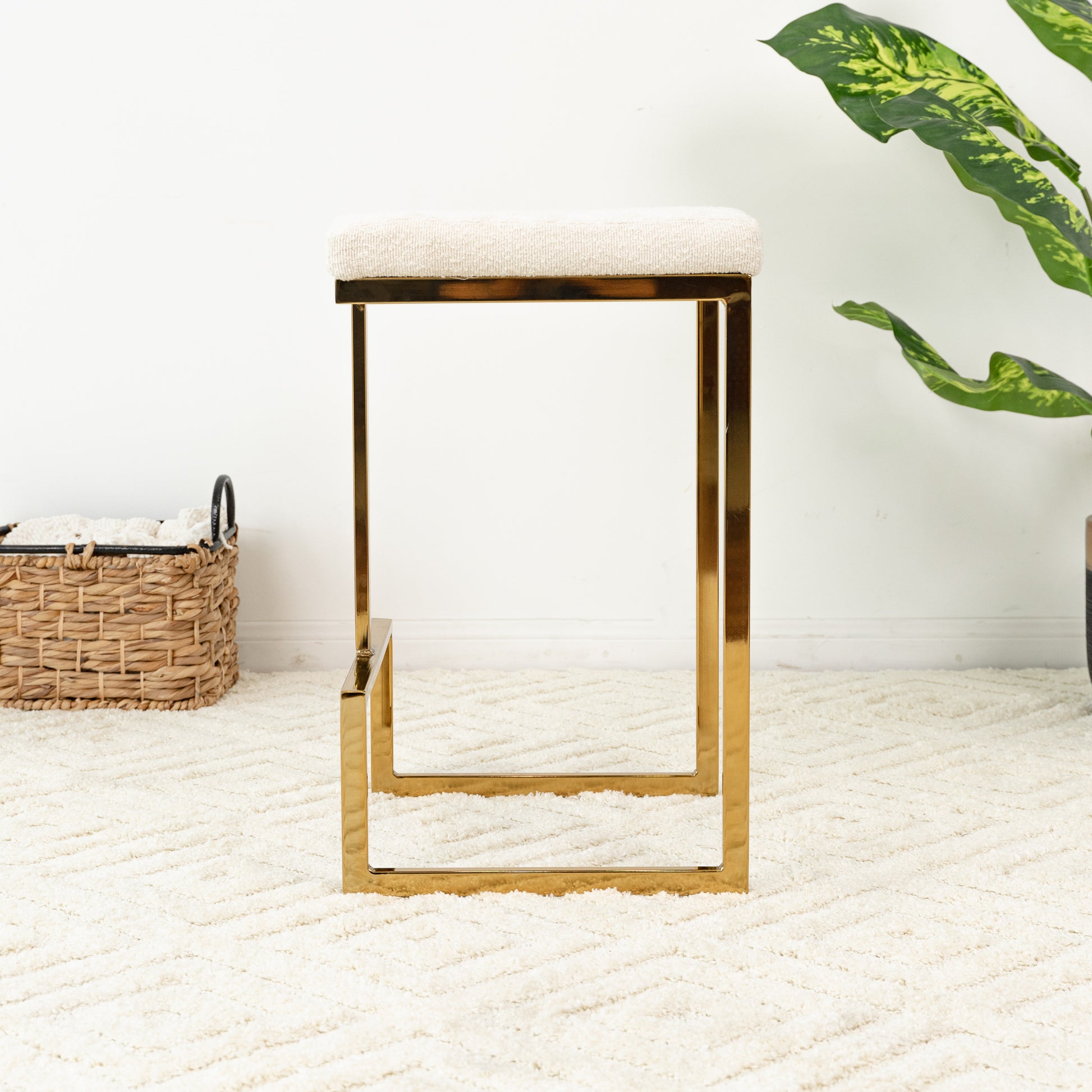 Modern cream textured bar stool with a polished gold metal frame perfect for kitchen islands