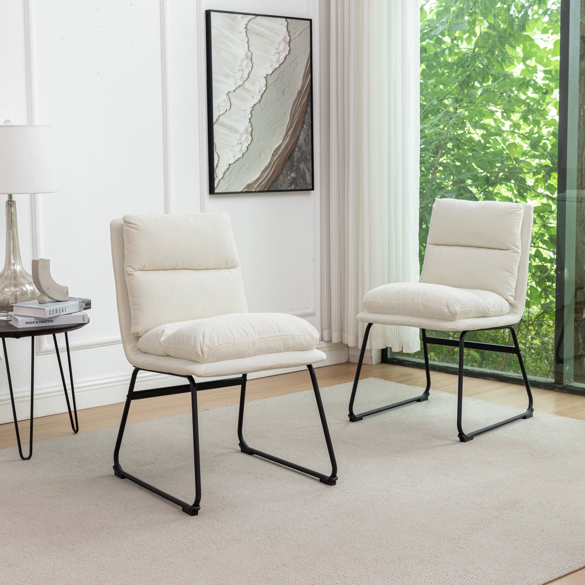 Cream upholstered accent chair with plush cushions and black metal legs
