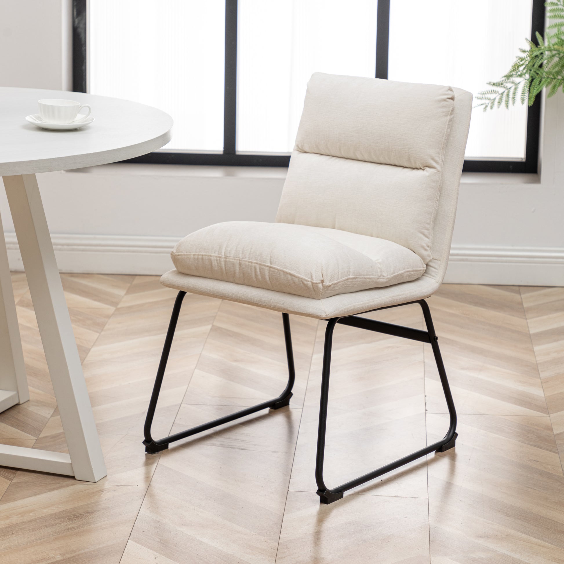 Cream fabric accent chair with black metal legs perfect for modern dining