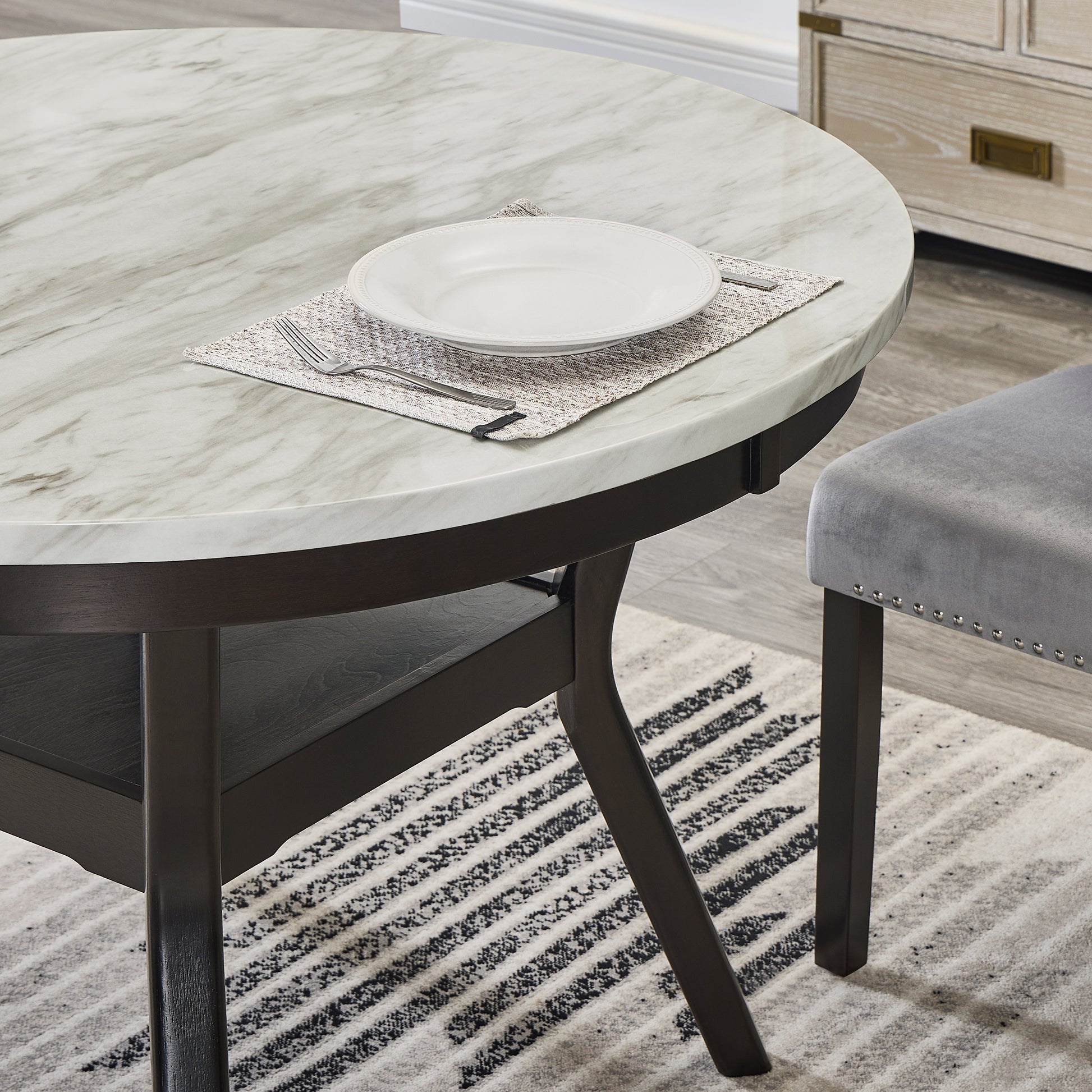 Round marble dining table with dark wood base set for one