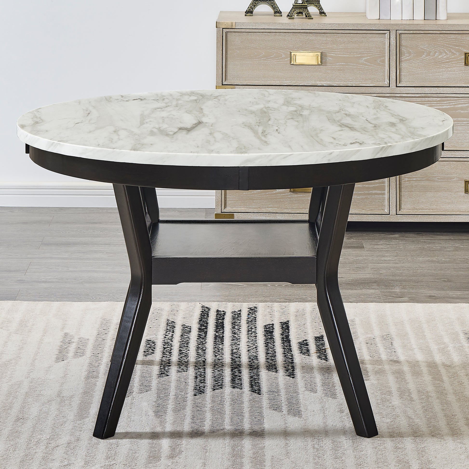 Round faux marble dining table with black wood base and modern design