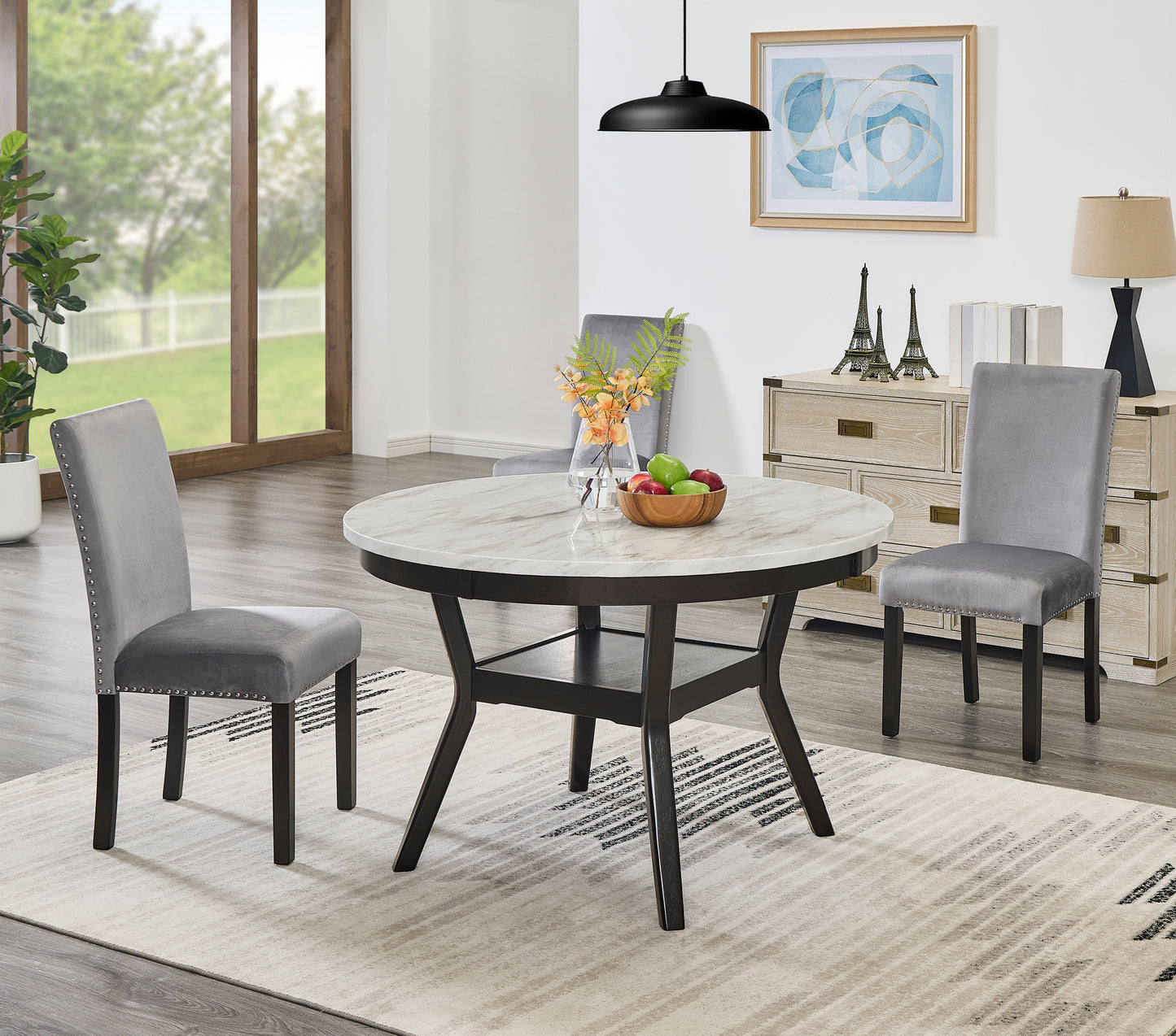 Round white marble top dining table with dark wood pedestal base seats four