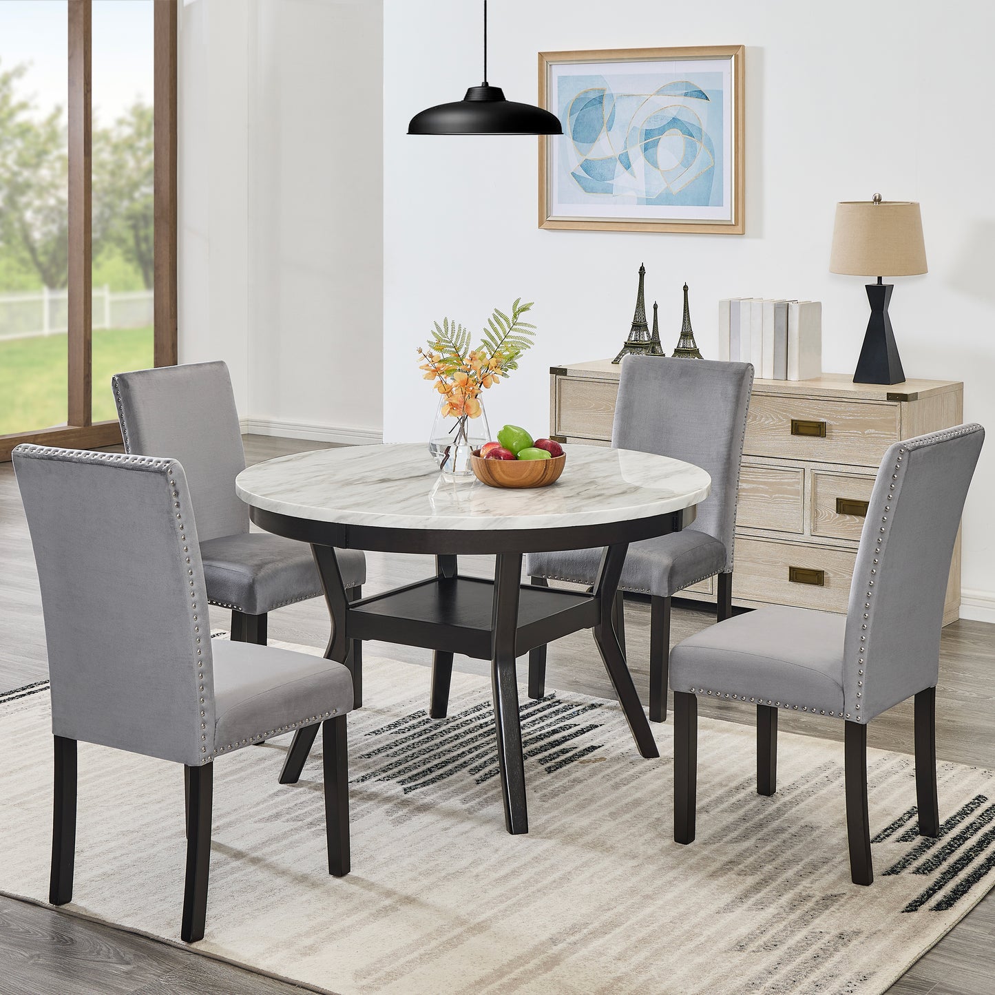 Round marble dining table with four grey velvet tufted chairs perfect for small spaces