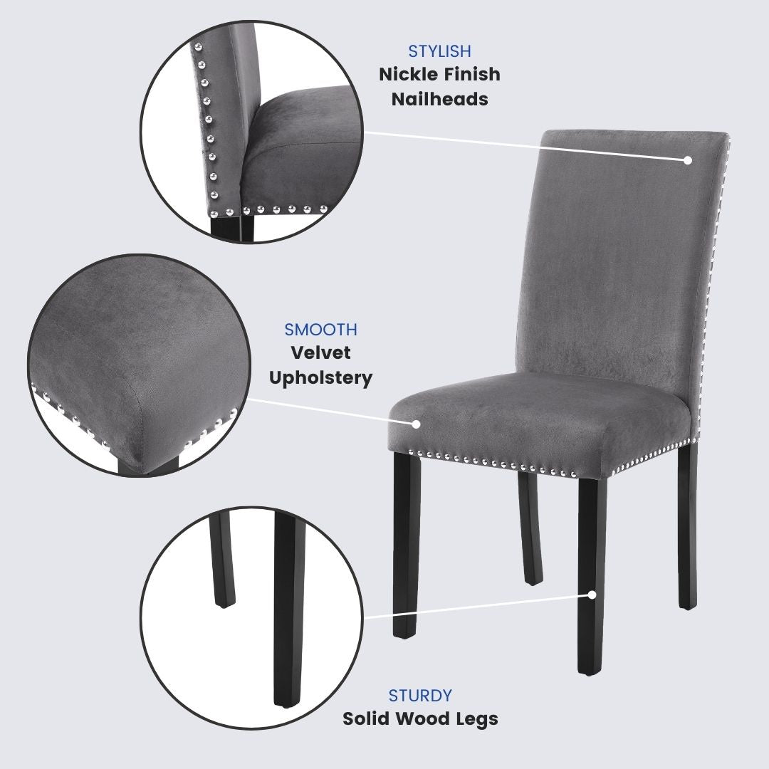 Grey velvet dining chair with silver nailhead trim and dark wood legs
