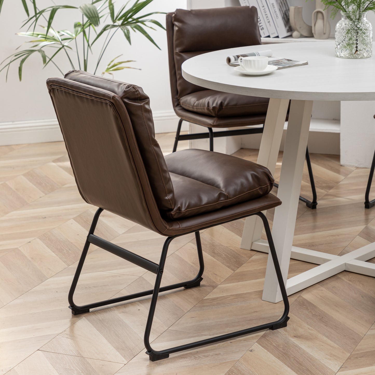 Plush brown faux leather dining chair with tufted seat and back black metal legs