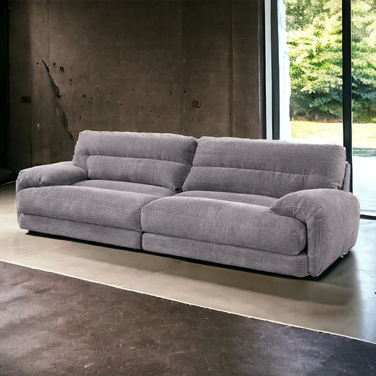 Gray corduroy sofa with deep seat cushions and plush backrests