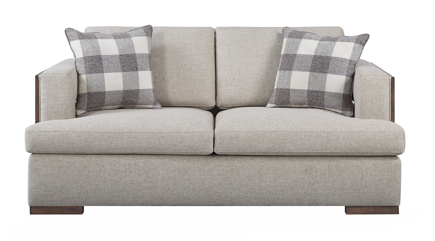 Twoseater modern sofa in beige fabric with plaid accent pillows and dark wood trim