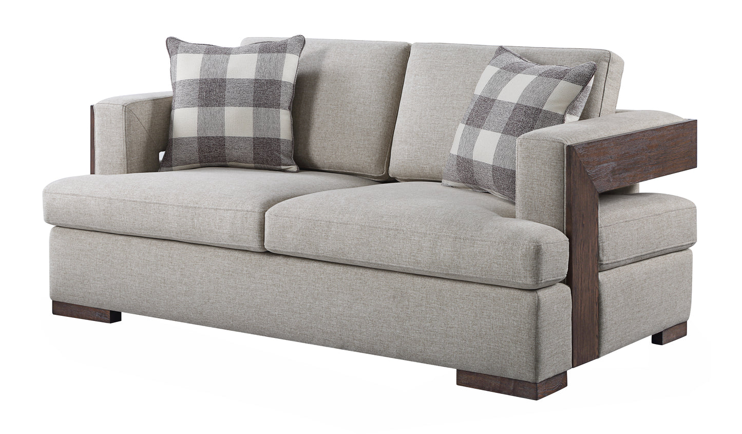 A contemporary beige sofa with dark wood arm accents and buffalo plaid accent pillows