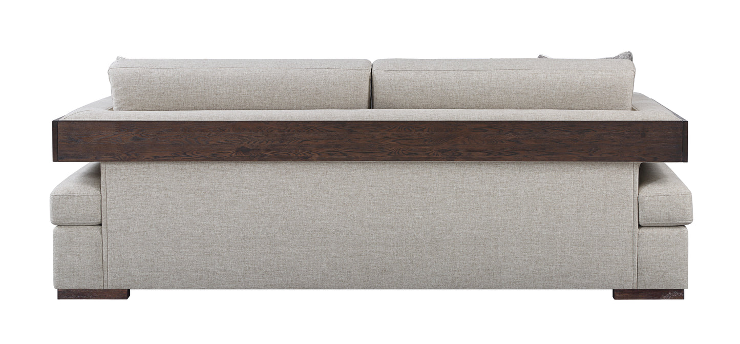 Back view of a modern beige fabric sofa with a dark wood accent