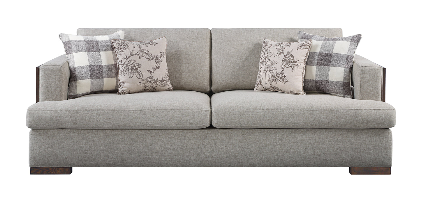 Textured light grey fabric sofa with accent pillows featuring plaid and floral patterns
