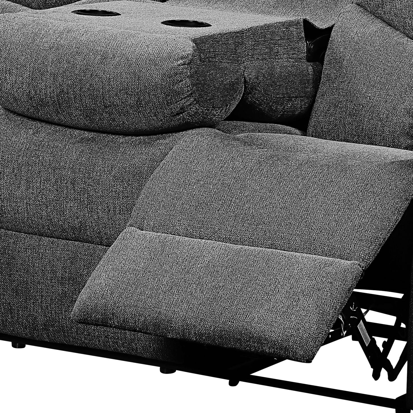 Closeup of a gray fabric recliner sofa with cup holders and extended footrest