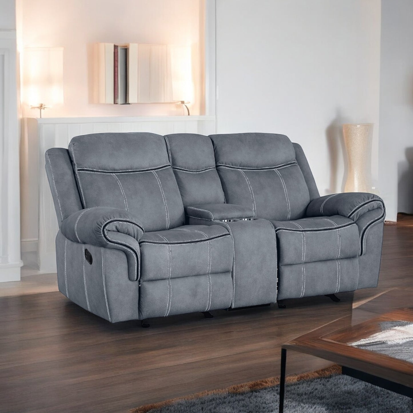 Gray reclining loveseat with white stitching and builtin cup holders