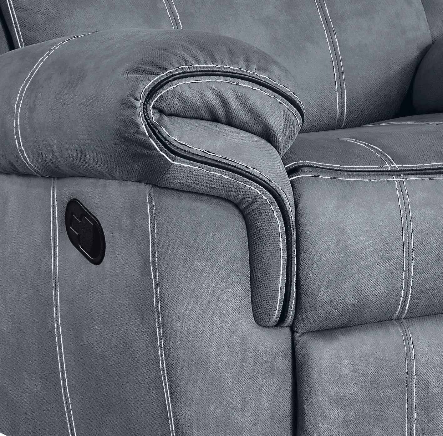 Closeup of a gray recliner sofa armrest with white stitching and lever