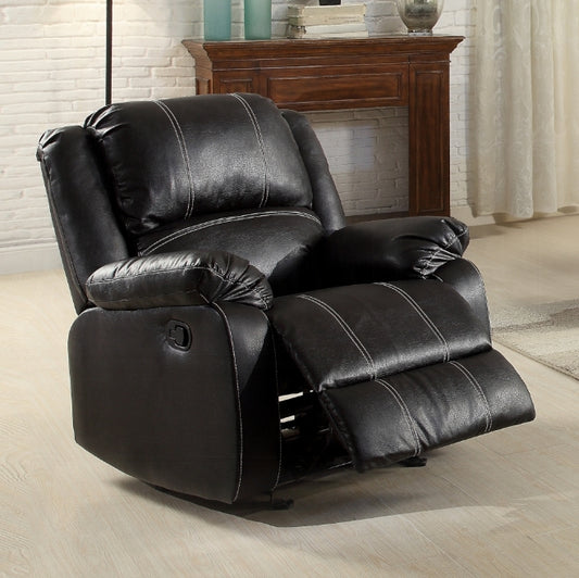 Black faux leather recliner chair with white stitching and extended footrest