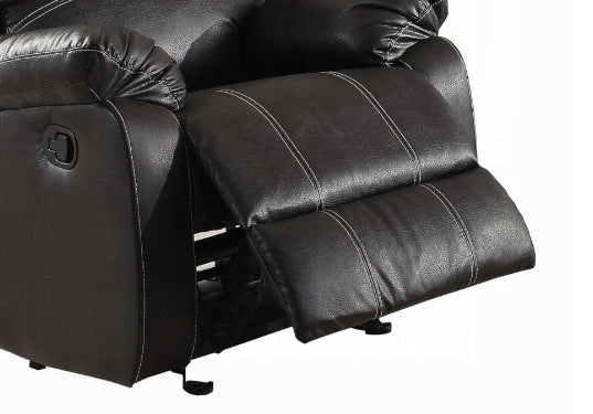 Closeup of a dark brown leather recliner chair with white stitching showing the footrest mechanism