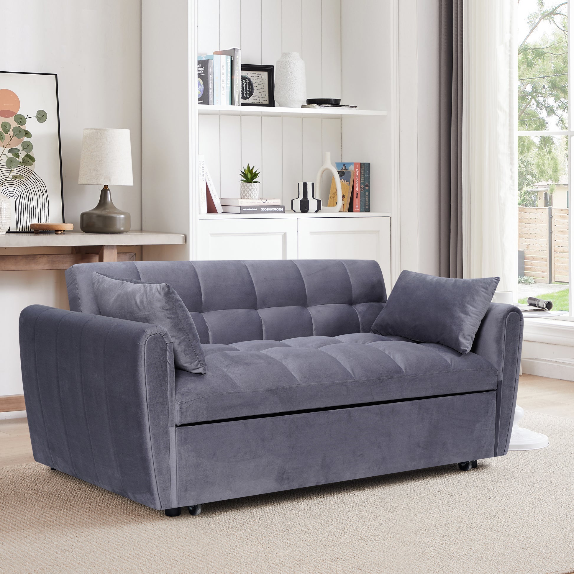 Tufted gray velvet sofa bed with plush cushions and modern design perfect for small spaces