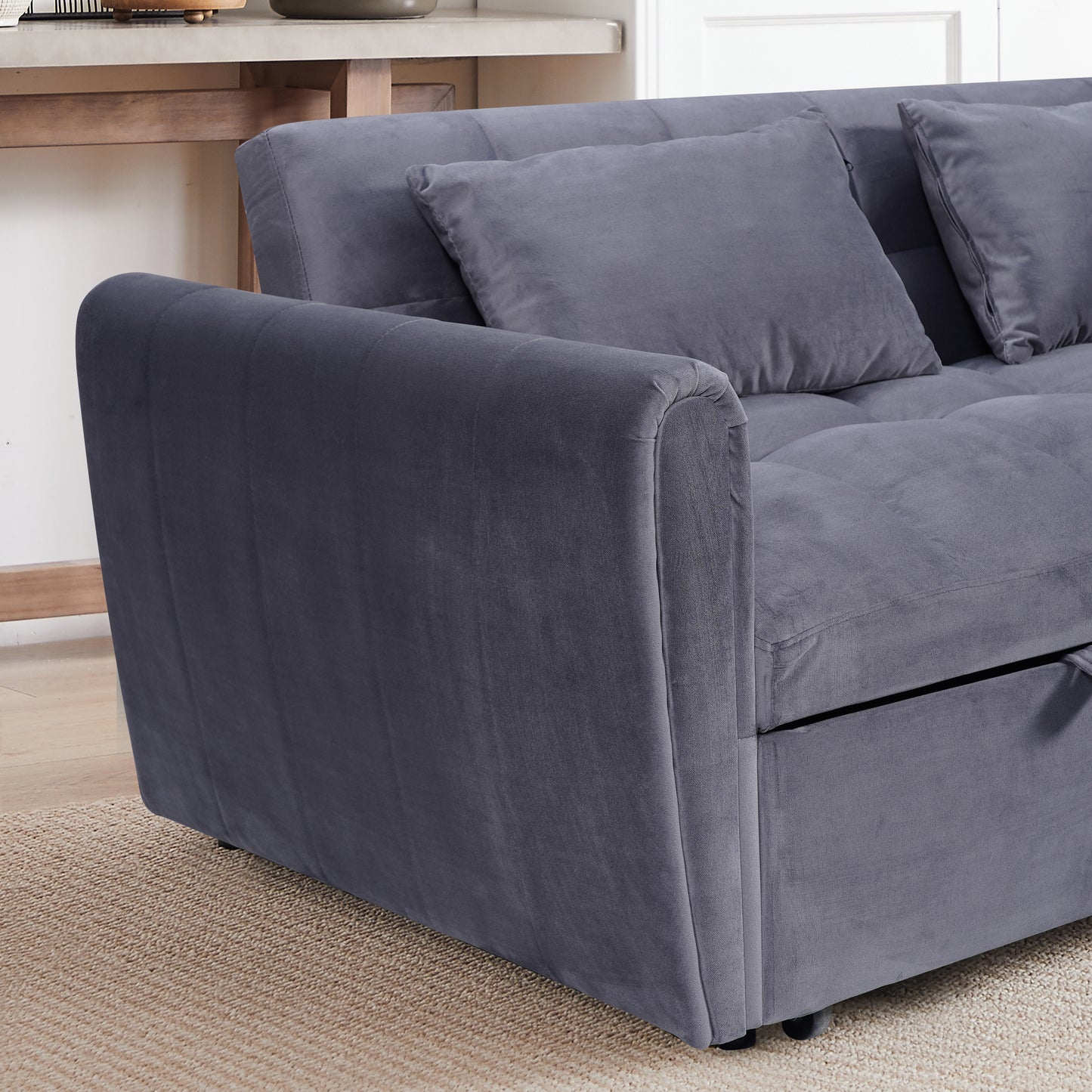 Dark gray velvet sofa with plush cushions and a tufted seat perfect for a modern living room