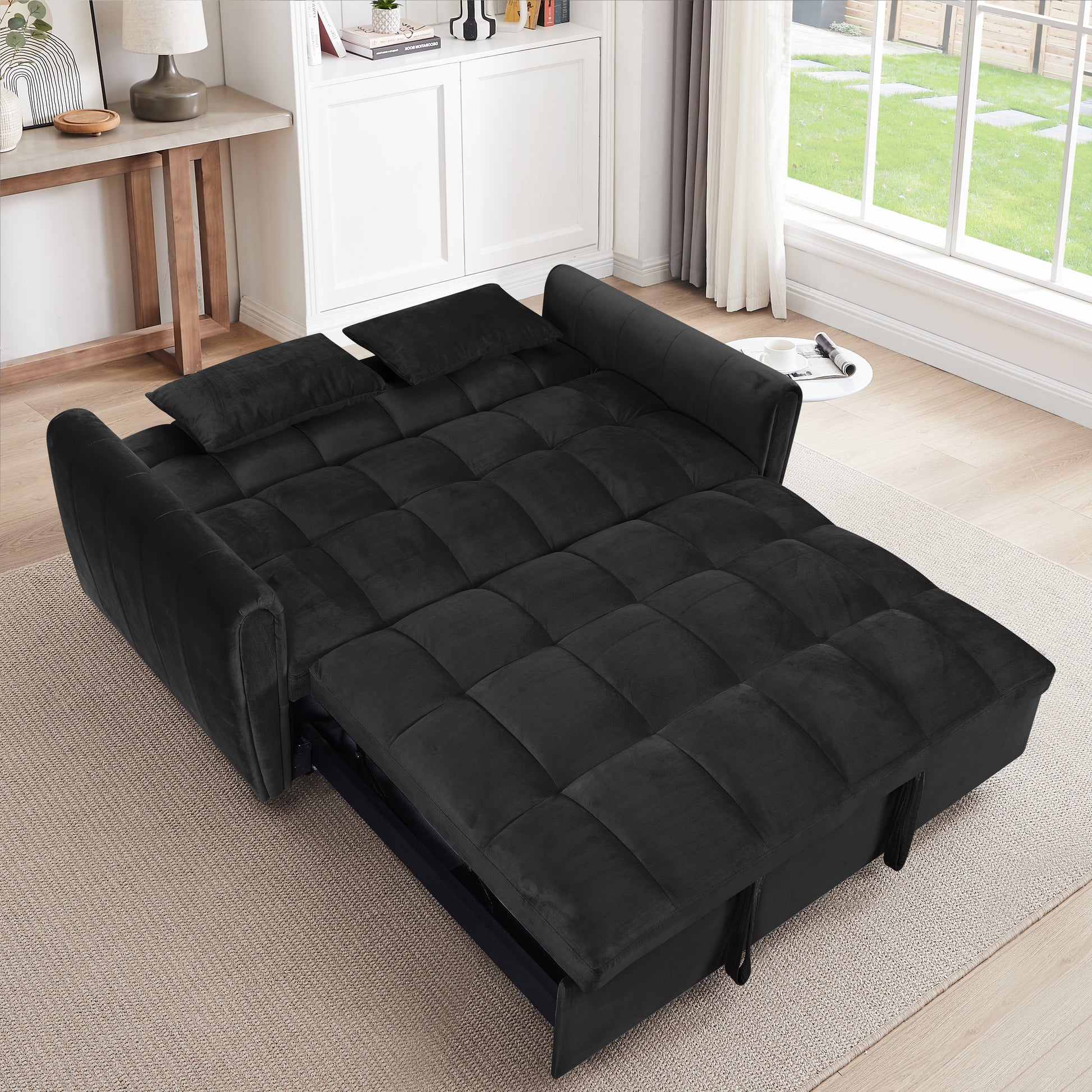 Plush black velvet sofa bed with tufted cushions and included pillows