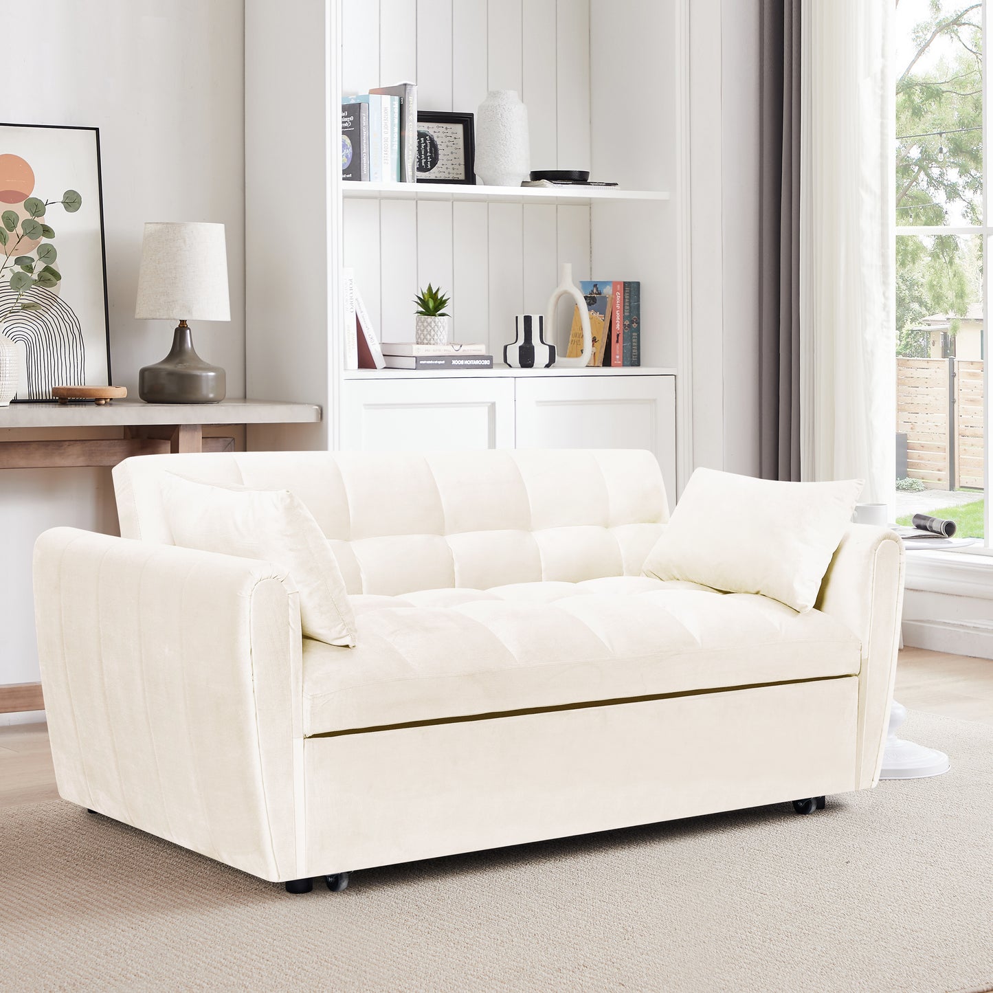 Cream velvet tufted sofa bed with matching throw pillow perfect for small spaces