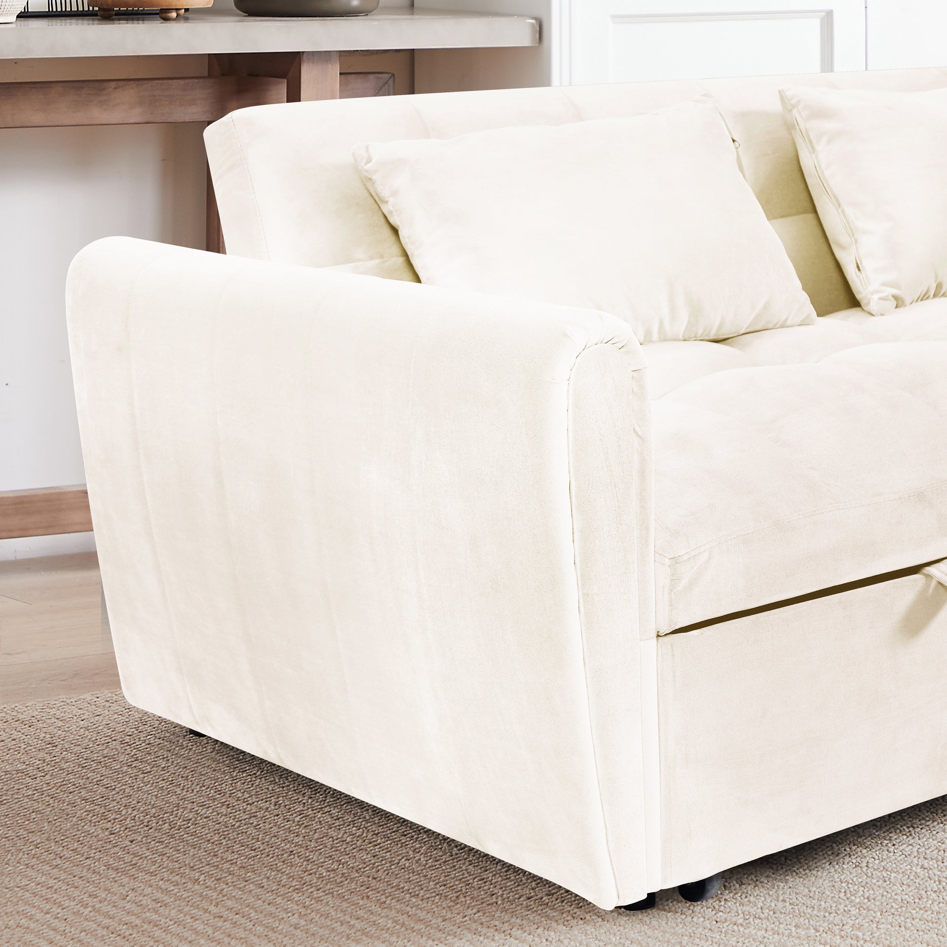 Cream velvet sofa with plush cushions and a modern design
