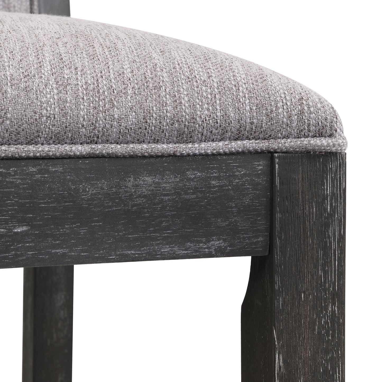 Closeup of a gray textured fabric cushion on a dark distressed wood chair frame