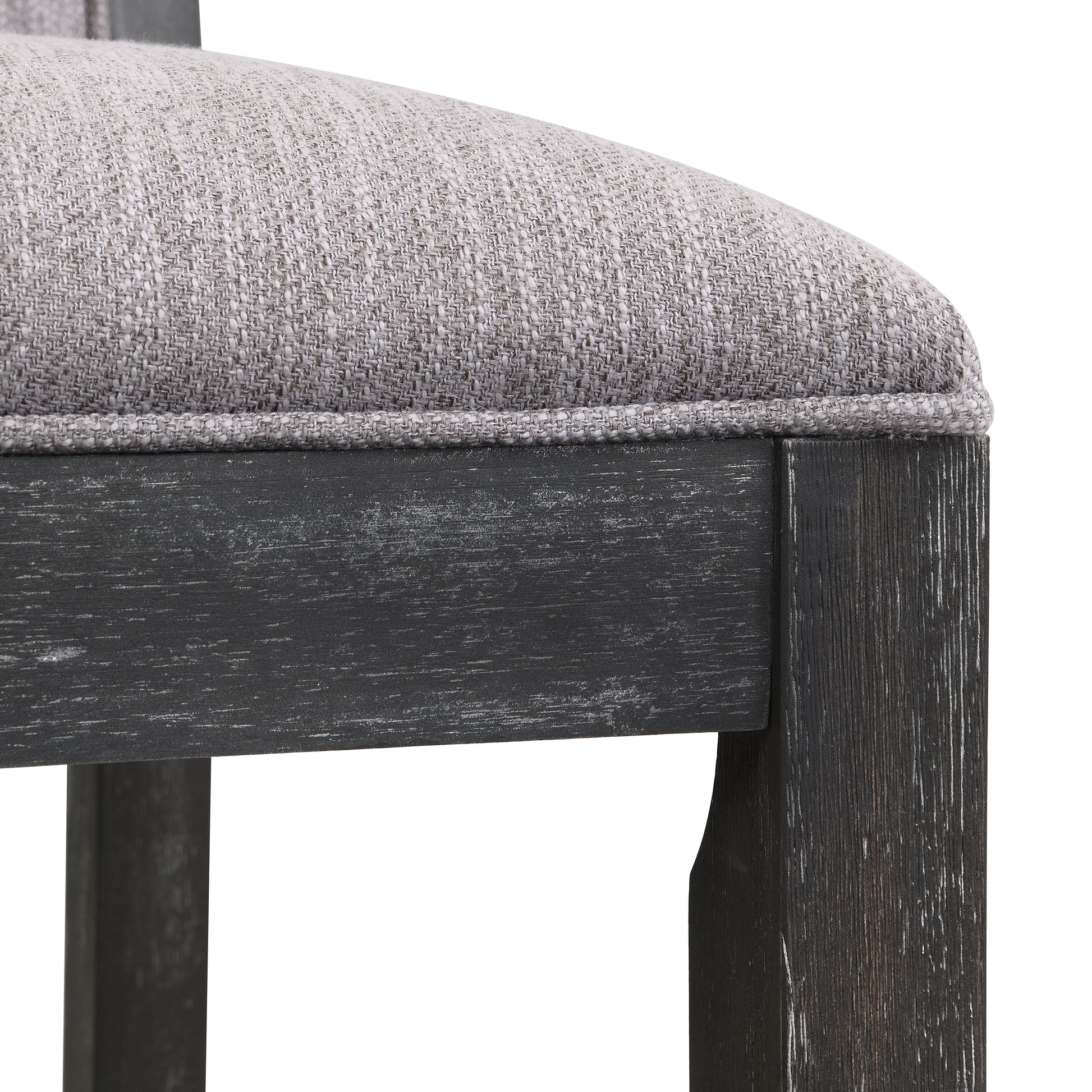 Closeup of a gray textured fabric cushion on a dark distressed wood chair frame