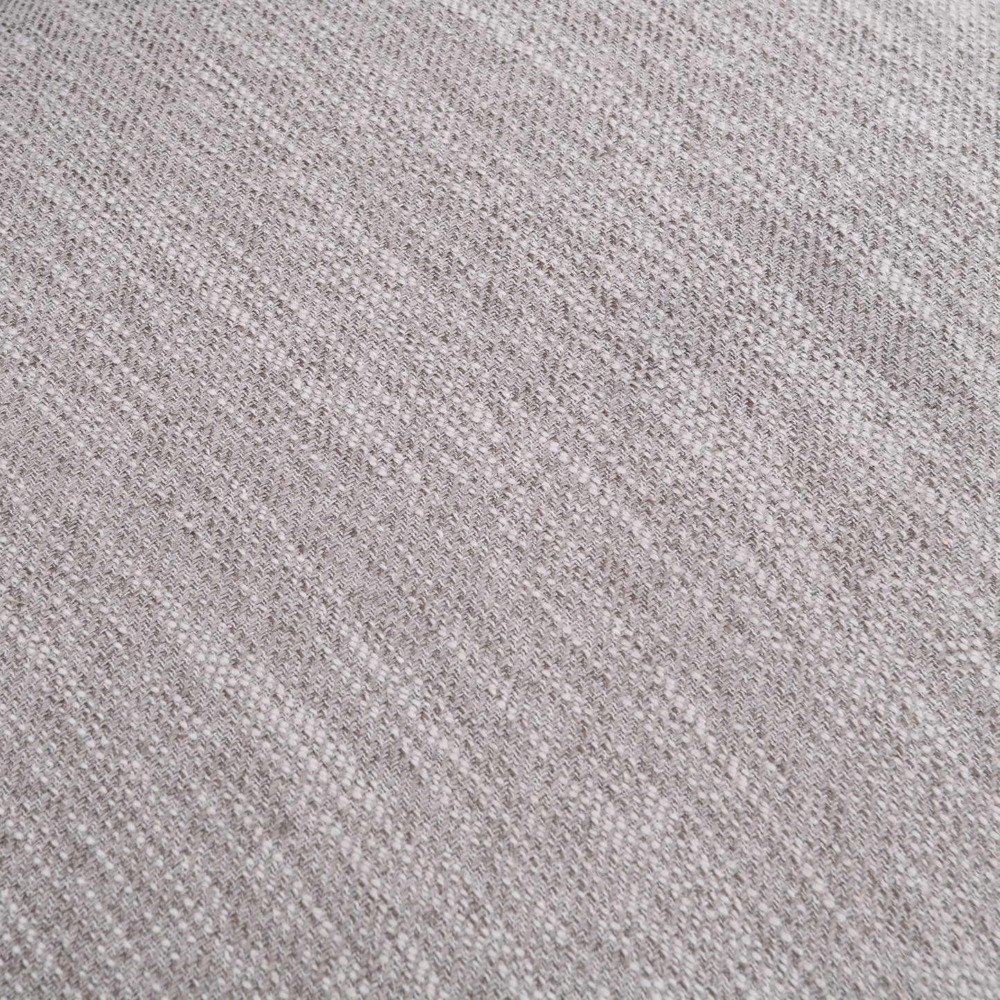 Closeup of light grey woven fabric with a subtle speckled texture