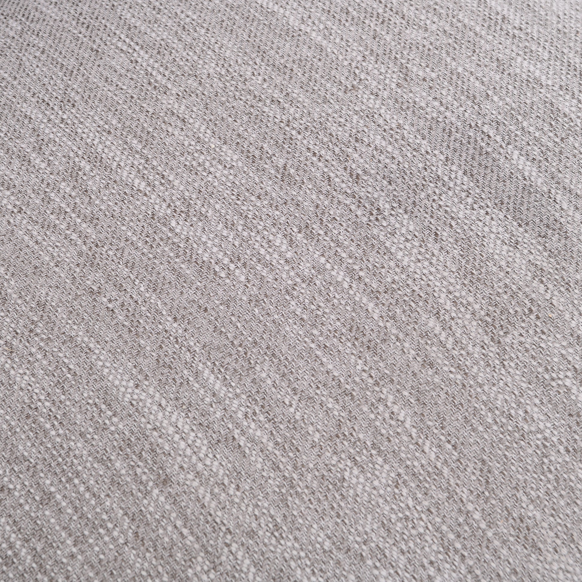 Closeup of light grey woven fabric with a subtle speckled texture