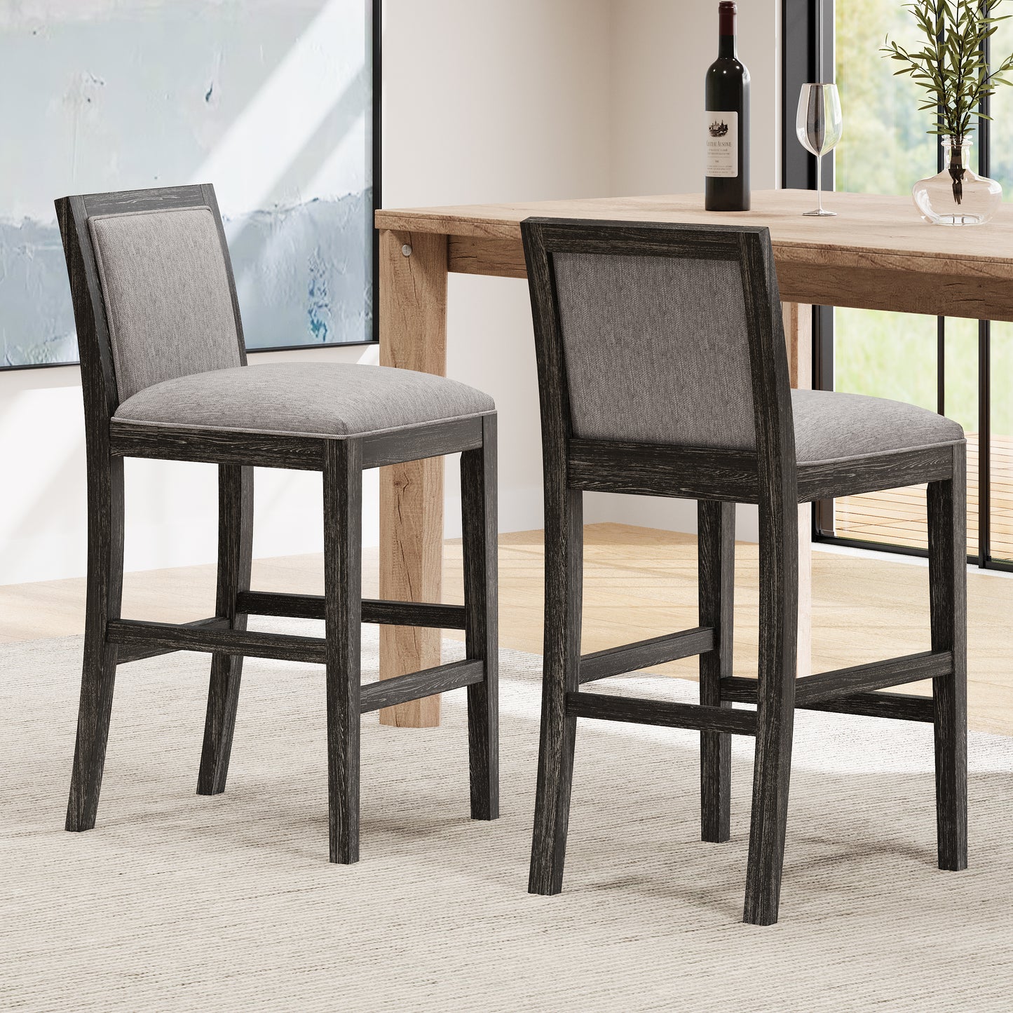 Two grey upholstered bar stools with distressed dark wood frames