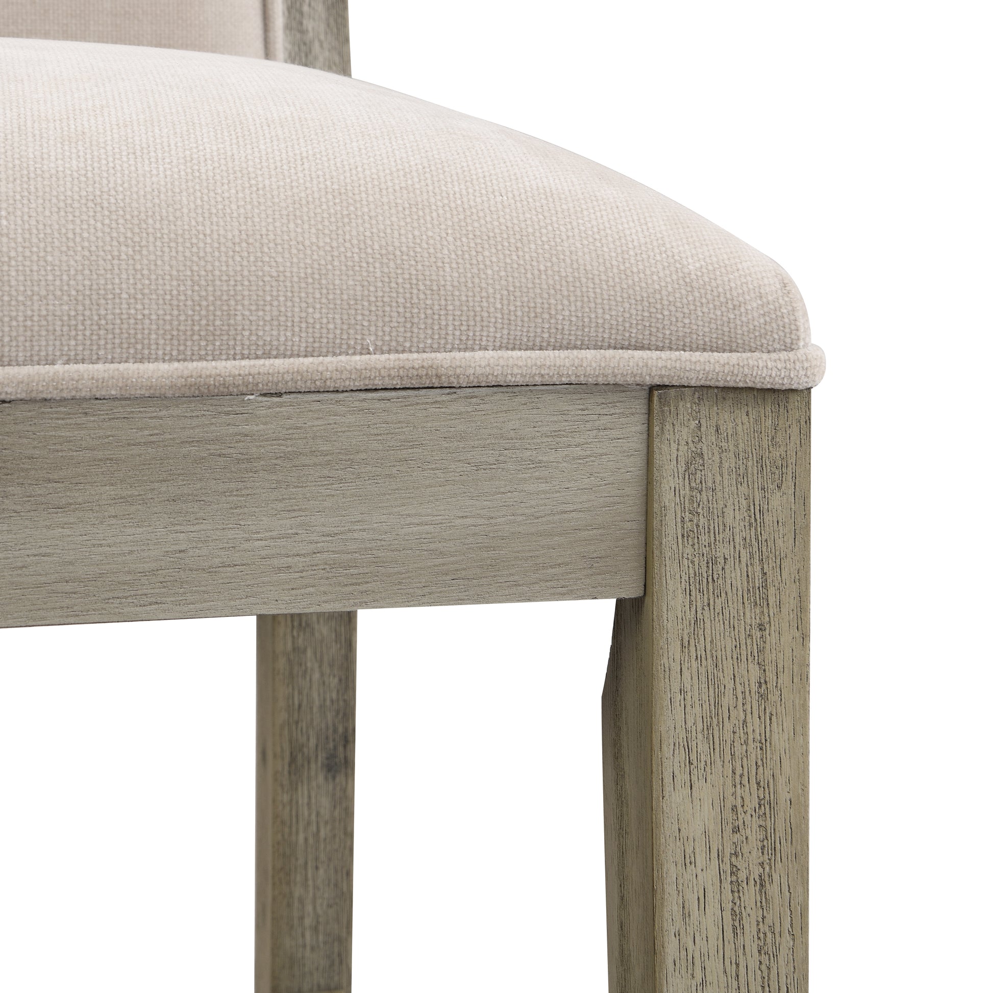 Close up of textured beige fabric seat cushion and distressed gray wood chair frame