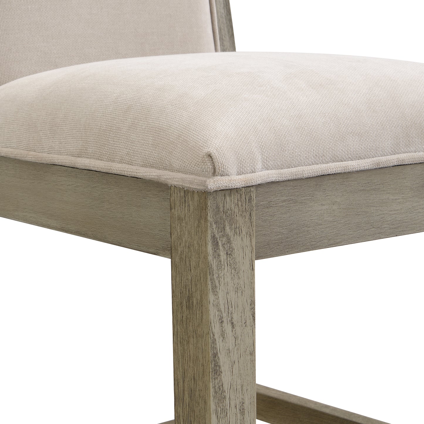 Closeup of a textured cream upholstered seat on a weathered grey wood frame chair