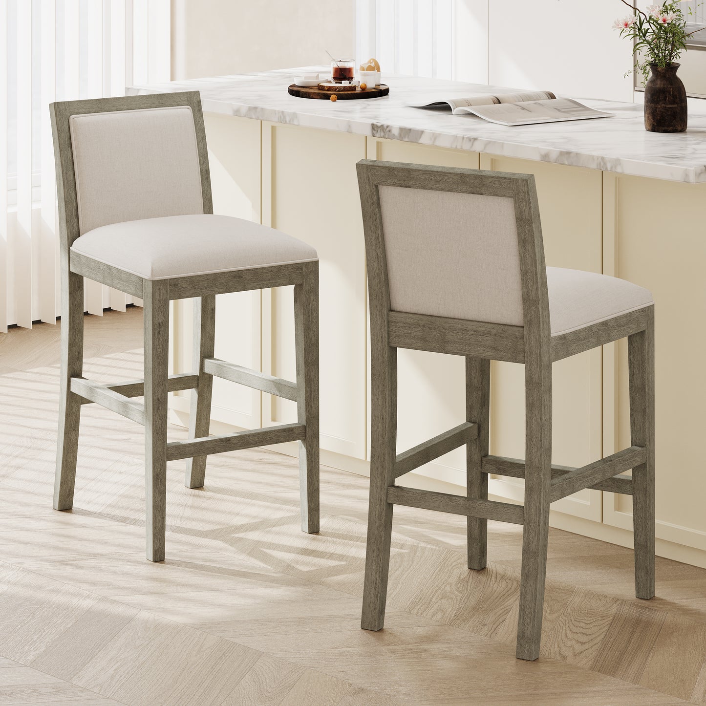 Two light gray wood and cream upholstered bar stools with plush seating for modern kitchens