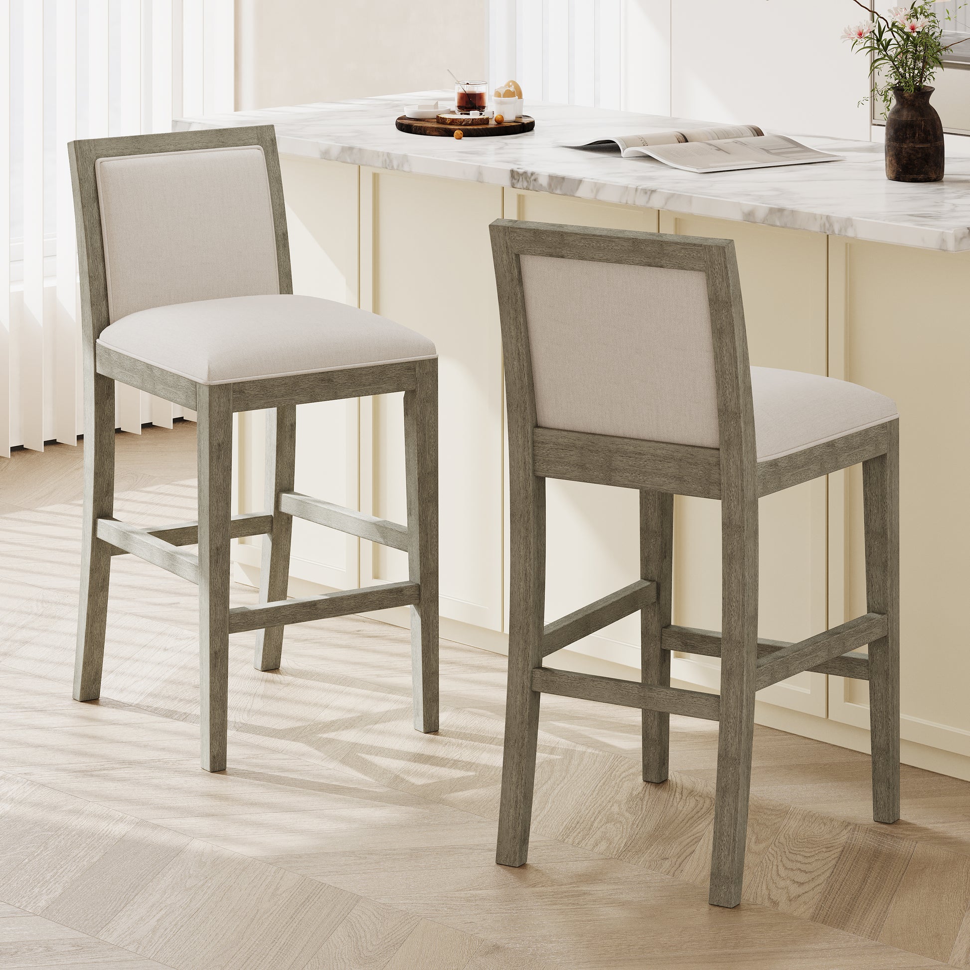 Two light gray wood and cream upholstered bar stools with plush seating for modern kitchens